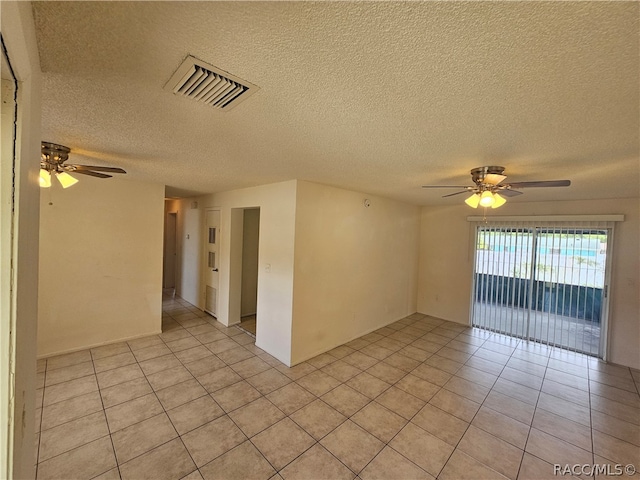 tiled spare room featuring ceiling fan and a textured ceiling