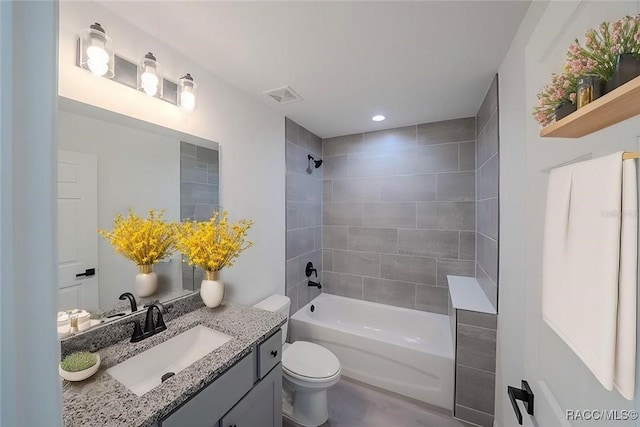 full bathroom with shower / bathing tub combination, toilet, wood finished floors, vanity, and visible vents