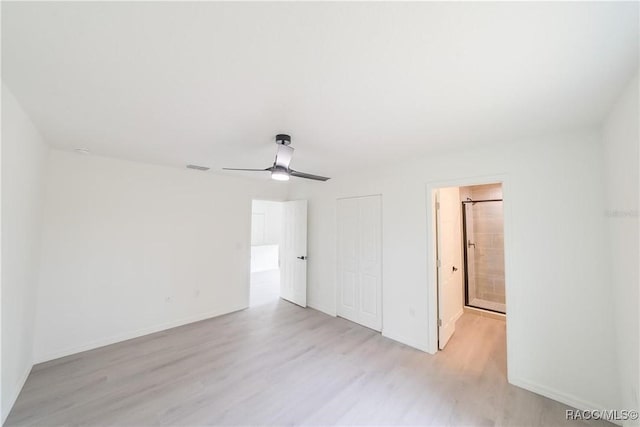 unfurnished bedroom featuring a closet, light wood-type flooring, baseboards, and a ceiling fan