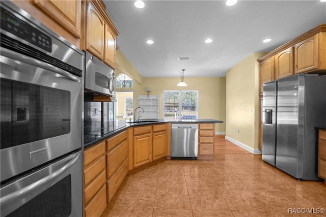 kitchen featuring pendant lighting, sink, appliances with stainless steel finishes, light tile patterned flooring, and kitchen peninsula