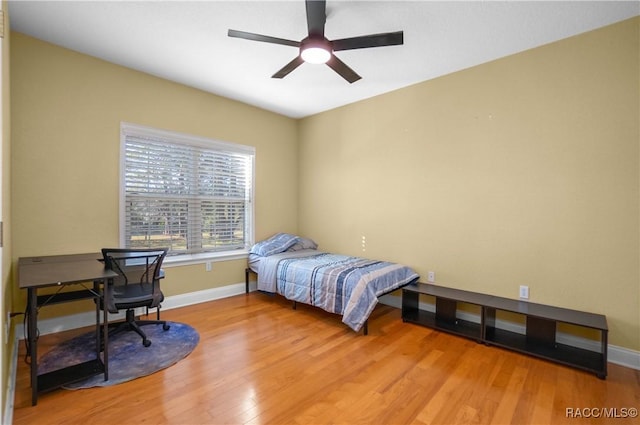 bedroom with ceiling fan and light wood-type flooring