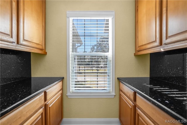 kitchen featuring dark stone countertops