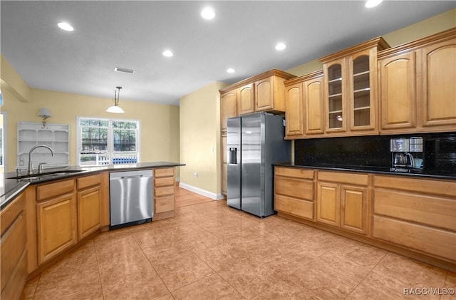 kitchen featuring sink, appliances with stainless steel finishes, hanging light fixtures, light tile patterned flooring, and decorative backsplash