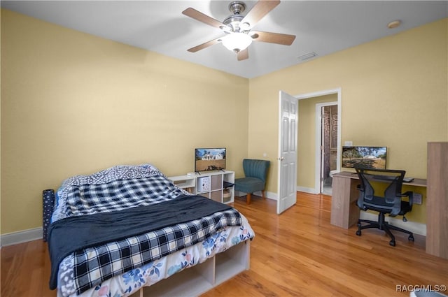 bedroom with ceiling fan and light hardwood / wood-style floors