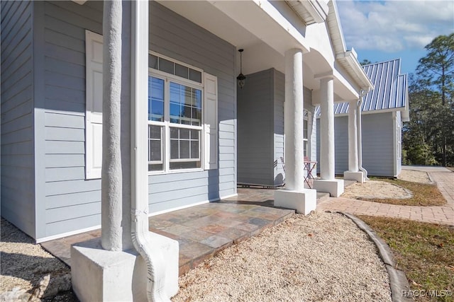 view of exterior entry featuring covered porch