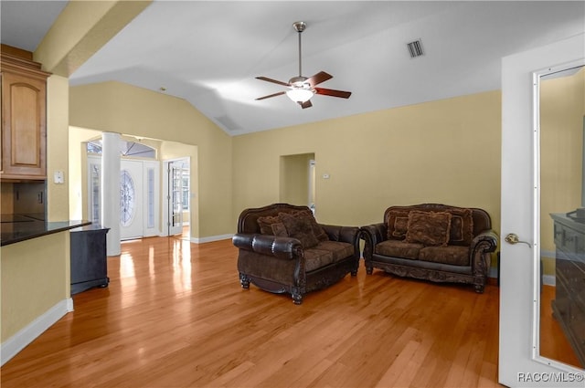 living room with ceiling fan, lofted ceiling, and light wood-type flooring