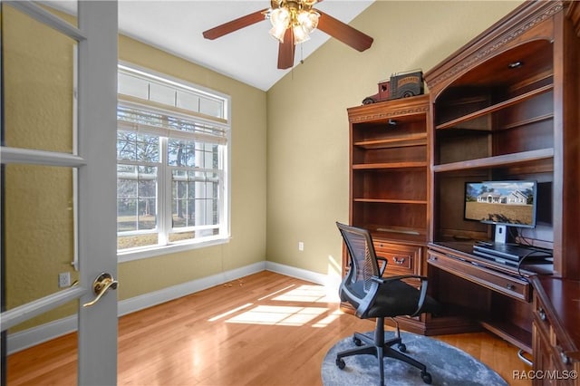 office featuring vaulted ceiling, light hardwood / wood-style floors, and ceiling fan