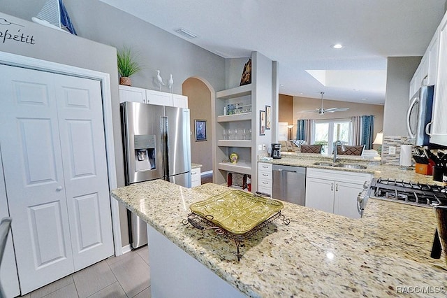 11938 W Blue Bayou Ct Unit 331, Crystal River, FL 34429 - kitchen with a sink, appliances with stainless steel finishes, light stone countertops, vaulted ceiling, and a peninsula