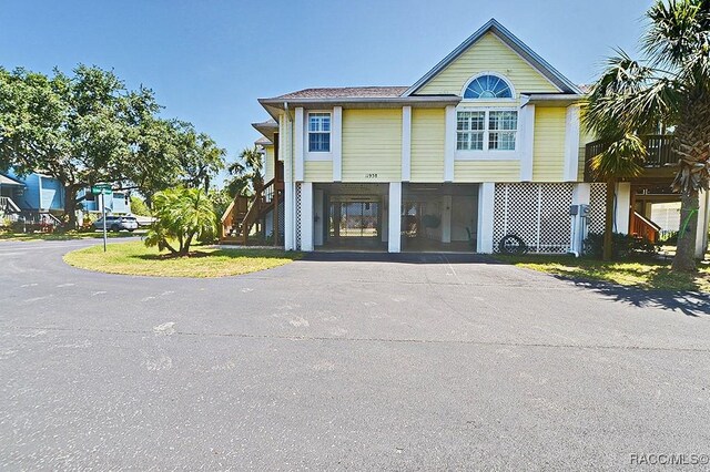 11938 W Blue Bayou Ct Unit 331, Crystal River, FL 34429 - view of front of home with driveway, stairway, and a carport