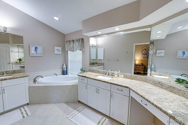 11938 W Blue Bayou Ct Unit 331, Crystal River, FL 34429 - full bathroom with lofted ceiling, a sink, two vanities, a garden tub, and tile patterned flooring