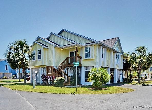 11938 W Blue Bayou Ct Unit 331, Crystal River, FL 34429 - view of front of property featuring a front lawn, driveway, stairway, and a carport