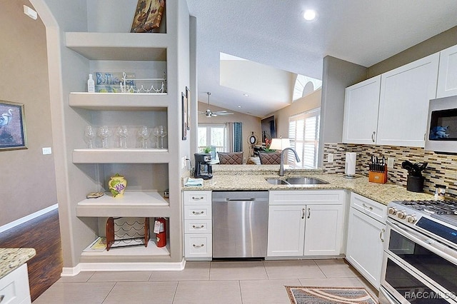 11938 W Blue Bayou Ct Unit 331, Crystal River, FL 34429 - kitchen with a sink, stainless steel appliances, open shelves, light stone counters, and white cabinetry