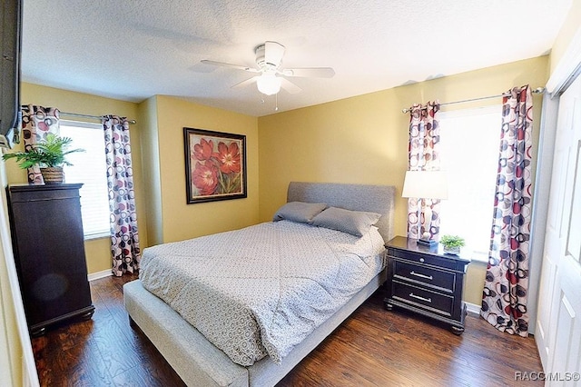 11938 W Blue Bayou Ct Unit 331, Crystal River, FL 34429 - bedroom featuring a textured ceiling, ceiling fan, dark wood-style floors, and baseboards
