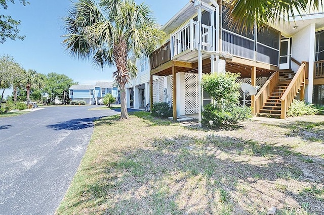 11938 W Blue Bayou Ct Unit 331, Crystal River, FL 34429 - view of side of property with stairway, aphalt driveway, and a sunroom