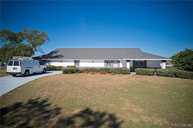 ranch-style home with a front lawn