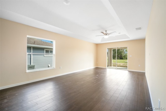 empty room featuring ceiling fan and dark wood-type flooring