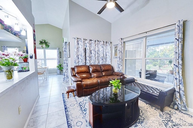 tiled living room with ceiling fan and lofted ceiling