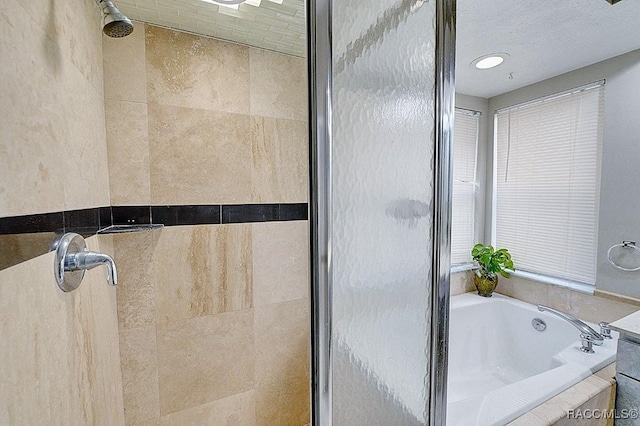 bathroom with separate shower and tub