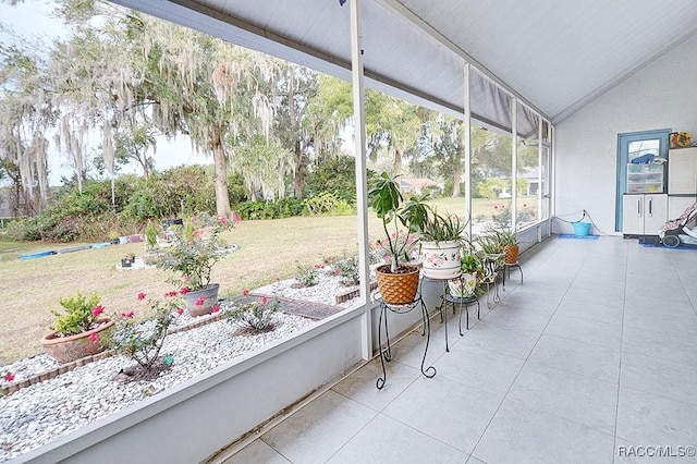 sunroom featuring vaulted ceiling