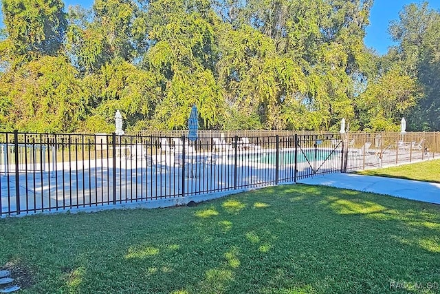 view of swimming pool featuring a lawn