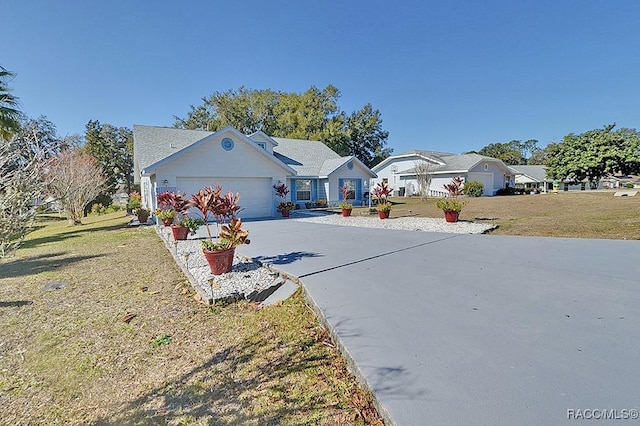 single story home featuring a front lawn and a garage