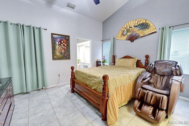 tiled bedroom featuring multiple windows, vaulted ceiling, and ceiling fan