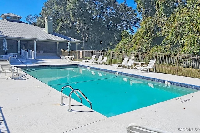 view of swimming pool with a patio area