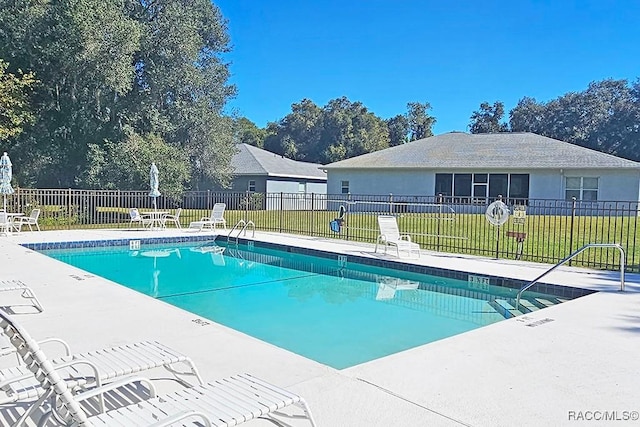 view of swimming pool featuring a yard and a patio