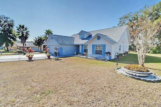 view of front of house with a garage and a front lawn