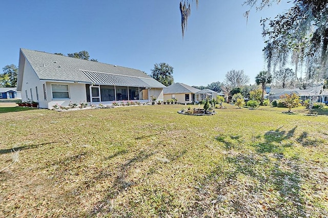 view of yard featuring a sunroom