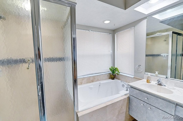 bathroom with vanity and separate shower and tub