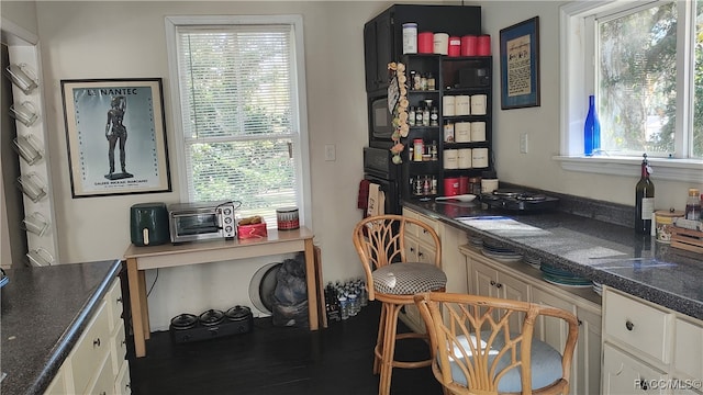 office space with plenty of natural light and dark hardwood / wood-style floors