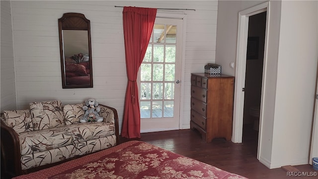 bedroom with dark hardwood / wood-style floors