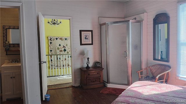 bedroom featuring multiple windows, dark hardwood / wood-style flooring, and sink