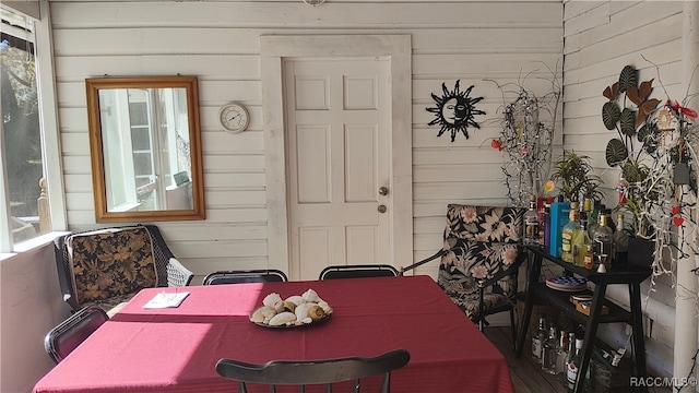 dining room featuring wood walls