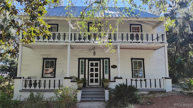 view of front of home featuring covered porch and a balcony