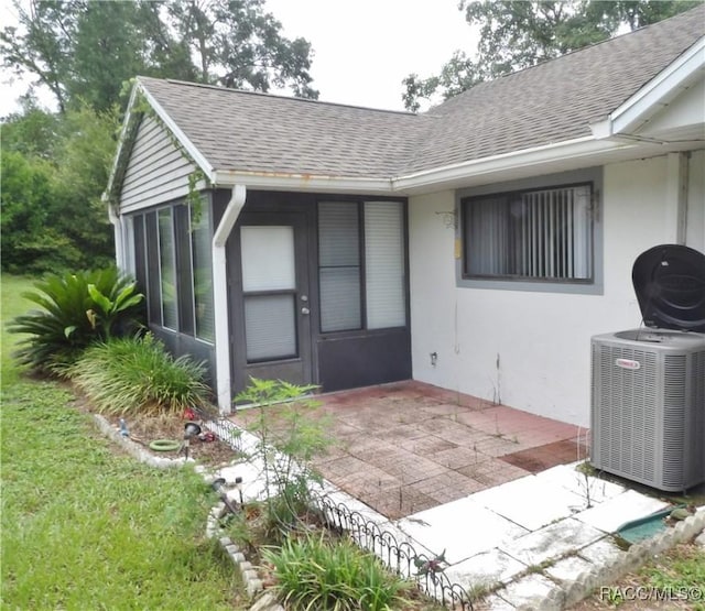 3966 N Spanish Moss Pt, Beverly Hills, FL 34465 - entrance to property featuring a shingled roof, a patio, and stucco siding