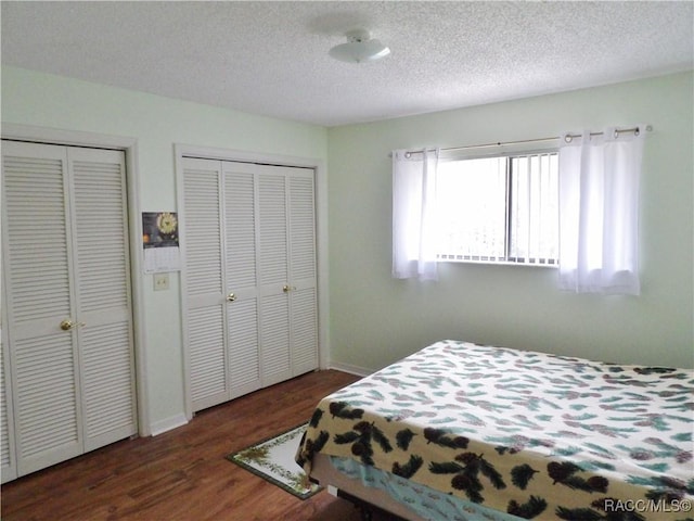 3966 N Spanish Moss Pt, Beverly Hills, FL 34465 - bedroom featuring two closets, wood finished floors, and a textured ceiling