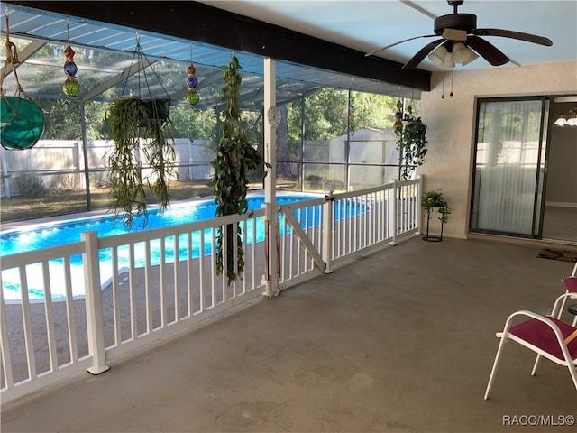 view of pool with a lanai, ceiling fan, and a patio