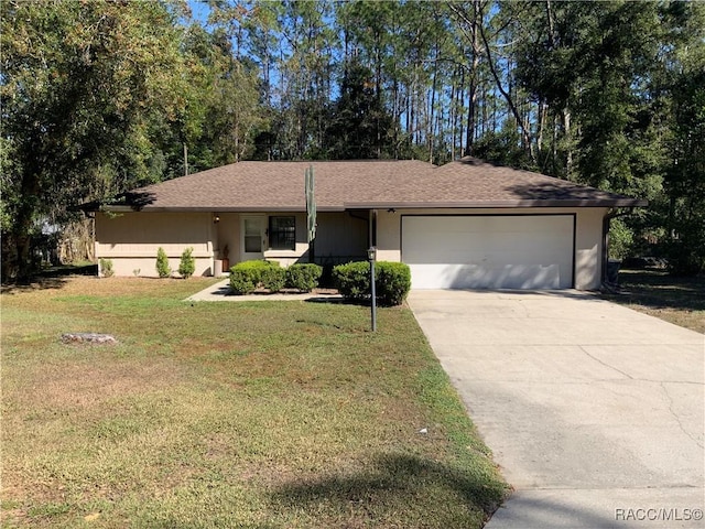 ranch-style home with a front lawn and a garage