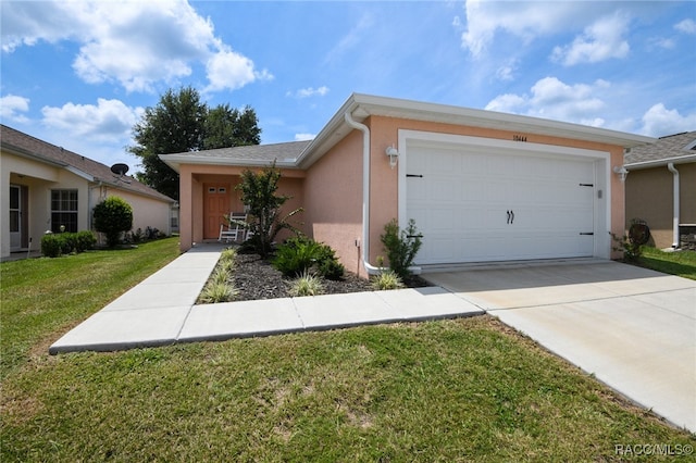 ranch-style home with a garage and a front lawn