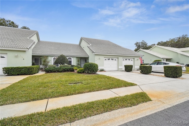 view of front of home with a front yard and a garage