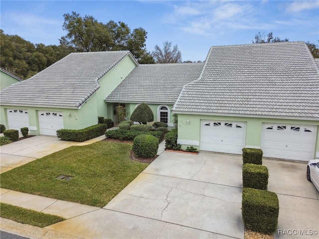 view of front of house featuring a front yard and a garage