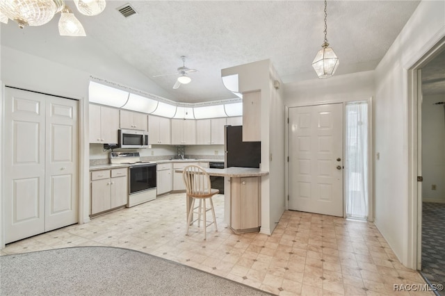 kitchen featuring appliances with stainless steel finishes, a kitchen breakfast bar, ceiling fan, decorative light fixtures, and white cabinets