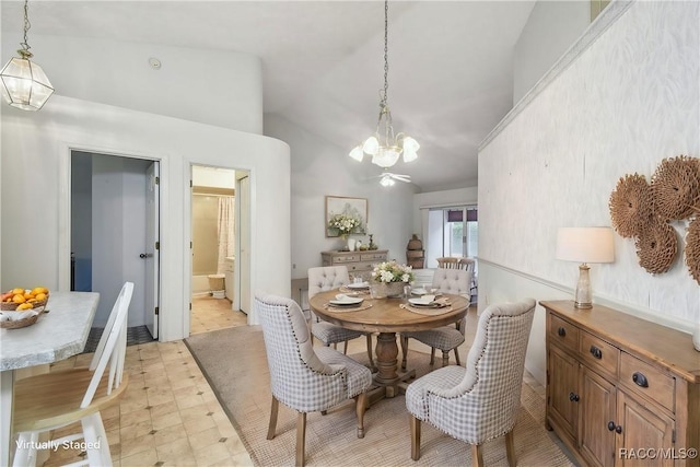 dining area featuring high vaulted ceiling and a notable chandelier