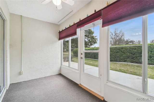 unfurnished sunroom with ceiling fan