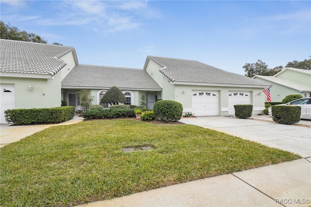 view of front of property with a garage and a front lawn