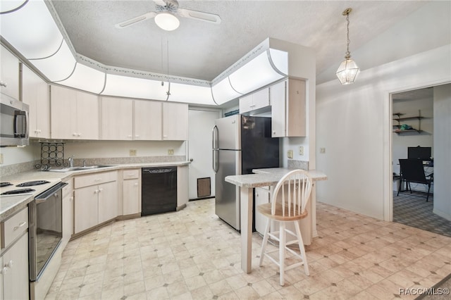 kitchen with decorative light fixtures, a textured ceiling, stainless steel appliances, and sink