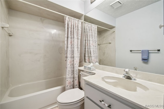 full bathroom featuring vanity, toilet, shower / bath combo with shower curtain, and a textured ceiling