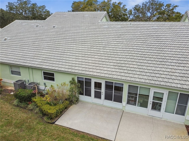 rear view of property with a patio and central AC unit